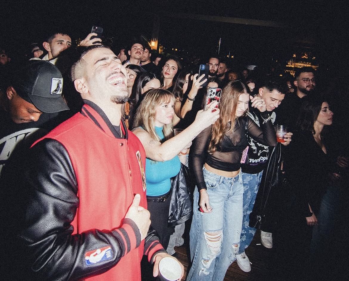 Rooftop crowd laughing — energy and atmosphere